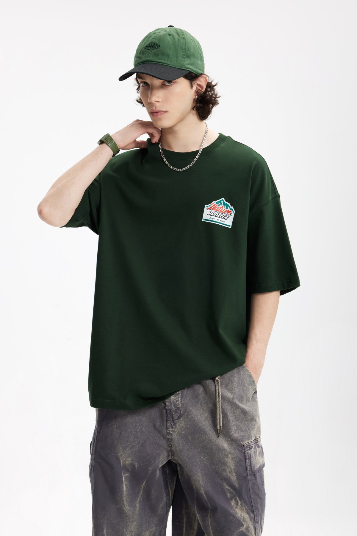 OLA FAN Dark Green Nature Protect T-shirt front side view on male model – minimalist high street wear