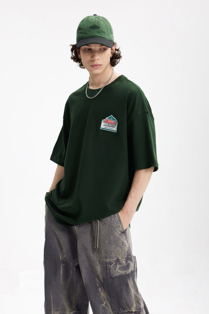 OLA FAN Dark Green Nature Protect T-shirt front side view on male model – minimalist high street wear