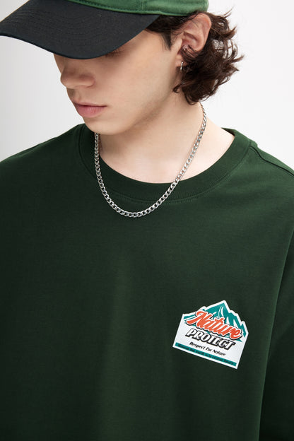 OLA FAN Dark Green Nature Protect T-shirt front side view on male model – minimalist high street wear